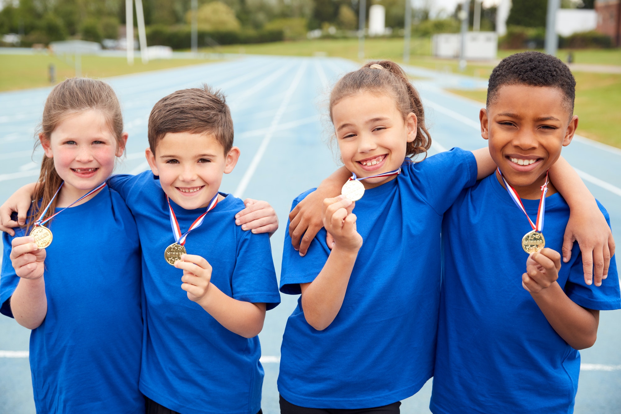 portrait-of-children-showing-off-winners-medals-on-sports-day.jpg
